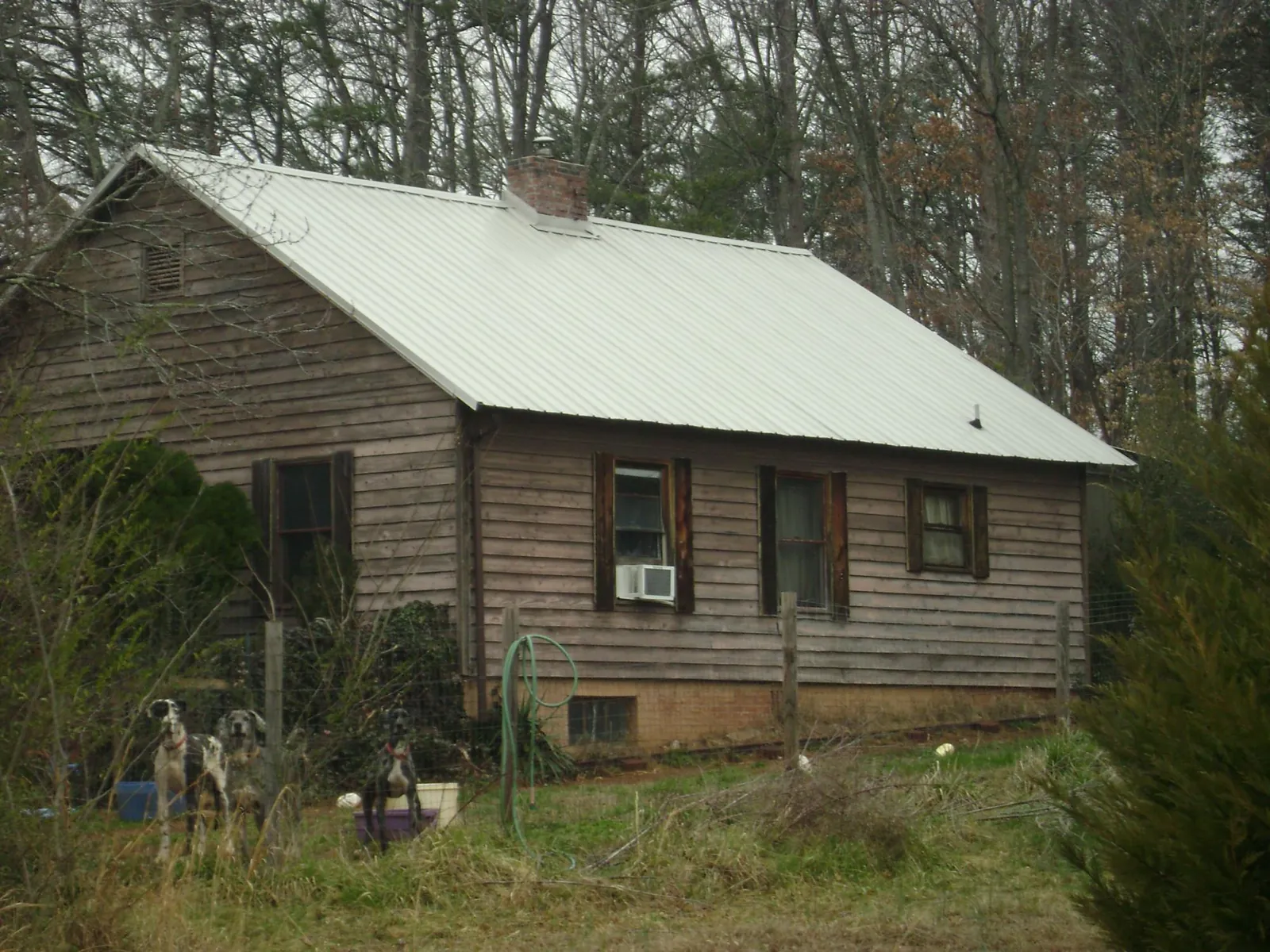 White metal roof on an old wood sided farmhouse, from a Metal Roof Installation job in Sully